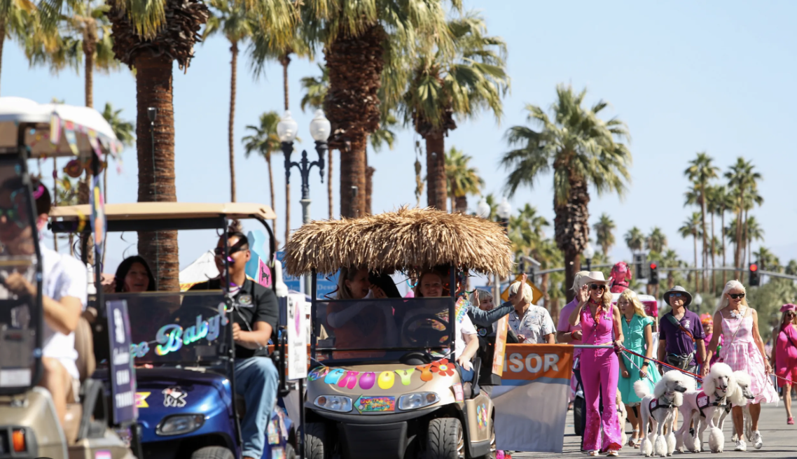 Golf cart on street with palms in background.