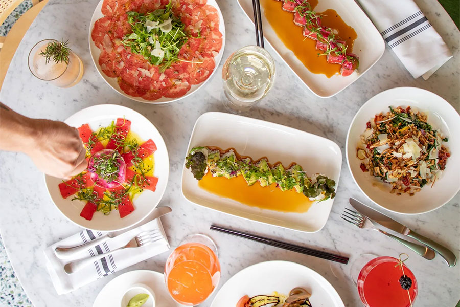 dining Overhead view of many dishes on a white marble table